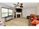 Comfortable living room with fireplace, large window, and ceiling fan at 5827 High Grass Ln, Indianapolis, IN 46235