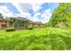Spacious backyard features lush green grass, mature trees, and a well-kept lawn at 6005 Apache Dr, Indianapolis, IN 46254
