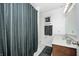 Cozy bathroom features a dark wood vanity, modern fixtures, and a decorative shower curtain at 6005 Apache Dr, Indianapolis, IN 46254