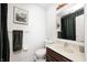 Bathroom with a dark wood vanity, tile flooring, framed Monet print, and stylish decor at 6005 Apache Dr, Indianapolis, IN 46254