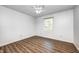 Clean, well-lit bedroom with wood-look flooring and neutral decor, complemented by a ceiling fan at 6005 Apache Dr, Indianapolis, IN 46254