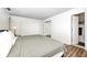 Well lit bedroom featuring wood floors, queen bed, and attached bathroom at 6005 Apache Dr, Indianapolis, IN 46254