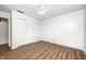 Bedroom with ample closet space, wood-look flooring, neutral walls, and ceiling fan at 6005 Apache Dr, Indianapolis, IN 46254