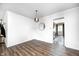 Bright dining room with hardwood floors and a stylish chandelier, leading into the kitchen at 6005 Apache Dr, Indianapolis, IN 46254