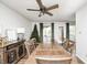Bright dining room featuring wood table and chairs, fan and view to sun room at 6005 Apache Dr, Indianapolis, IN 46254