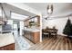Open kitchen with wood cabinets, stainless appliances, and view to dining area at 6005 Apache Dr, Indianapolis, IN 46254
