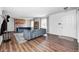 Bright living room featuring new flooring, a brick fireplace, and modern furnishings at 6005 Apache Dr, Indianapolis, IN 46254