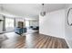 Open living room with hardwood floors, modern sofas, and a view to the kitchen at 6005 Apache Dr, Indianapolis, IN 46254