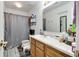 Functional bathroom with single sink, oak cabinets, and shower with curtain at 6190 E Ayrshire Cir, Camby, IN 46113