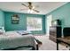 This bright bedroom features a large window and a ceiling fan with a light at 6190 E Ayrshire Cir, Camby, IN 46113