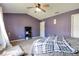 A comfortable bedroom features a ceiling fan and a bed with a gray quilt at 6190 E Ayrshire Cir, Camby, IN 46113
