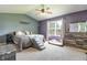Cozy bedroom with a ceiling fan, large window, and comfortable furnishings at 6190 E Ayrshire Cir, Camby, IN 46113