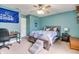 Bright bedroom features a ceiling fan and a comfortable bed with Colts themed decor at 6190 E Ayrshire Cir, Camby, IN 46113