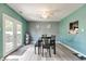 Bright dining room with a modern table and seating, and a view of the outdoor deck at 6190 E Ayrshire Cir, Camby, IN 46113