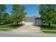 Exterior shot of three car garage and well-maintained landscaping at 6190 E Ayrshire Cir, Camby, IN 46113