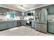 Modern kitchen featuring stainless steel appliances, gray cabinets, and stylish countertops at 6190 E Ayrshire Cir, Camby, IN 46113
