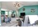Bright and open living room featuring comfortable seating, a ceiling fan, and plenty of natural light at 6190 E Ayrshire Cir, Camby, IN 46113