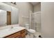 Bathroom with a sink, toilet, and glass-enclosed shower at 6354 Cotton Bay N Dr, Indianapolis, IN 46254
