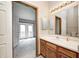 Bright bathroom featuring a vanity with wood cabinets, neutral countertops, and a large mirror at 6354 Cotton Bay N Dr, Indianapolis, IN 46254