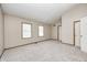 An empty bedroom with neutral walls, two windows, and carpet flooring at 6354 Cotton Bay N Dr, Indianapolis, IN 46254