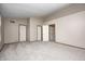 A bedroom with carpet flooring, and neutral walls with three doors at 6354 Cotton Bay N Dr, Indianapolis, IN 46254