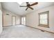 A bedroom featuring carpet flooring, neutral walls, a ceiling fan and a set of French doors at 6354 Cotton Bay N Dr, Indianapolis, IN 46254