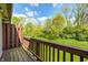 A wood deck overlooking a lush green lawn and trees with a blue sky at 6354 Cotton Bay N Dr, Indianapolis, IN 46254