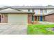 Charming brick townhome with a well-manicured lawn and two-car garage, inviting curb appeal at 6354 Cotton Bay N Dr, Indianapolis, IN 46254