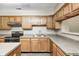 A kitchen featuring wooden cabinets, stainless steel appliances, and neutral countertops at 6354 Cotton Bay N Dr, Indianapolis, IN 46254
