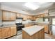 Well-lit kitchen featuring modern appliances, an island, and ample counter space at 6354 Cotton Bay N Dr, Indianapolis, IN 46254
