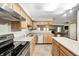 Bright kitchen featuring stainless steel appliances, countertop, and wooden cabinets at 6354 Cotton Bay N Dr, Indianapolis, IN 46254