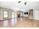 Bright living room featuring beautiful hardwood floors, a fireplace, and a staircase at 6354 Cotton Bay N Dr, Indianapolis, IN 46254