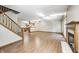 Open-concept living room with hardwood floors, fireplace, and stairway at 6354 Cotton Bay N Dr, Indianapolis, IN 46254