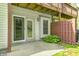 Patio with glass doors leading to the interior, complemented by green shrubbery at 6354 Cotton Bay N Dr, Indianapolis, IN 46254