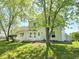 Private backyard surrounded by mature trees, and featuring a white deck offering a peaceful retreat at 6369 Kelsey Dr, Indianapolis, IN 46268