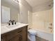 Bathroom featuring a wood vanity with modern faucet, white shower tub combo, and a new toilet at 6369 Kelsey Dr, Indianapolis, IN 46268