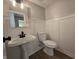 Well-lit half bathroom features decorative wall trim and pedestal sink at 6369 Kelsey Dr, Indianapolis, IN 46268