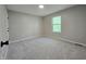 Bedroom with gray walls, carpet, and a window at 6369 Kelsey Dr, Indianapolis, IN 46268