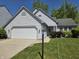 Charming single-Gathering home with well-manicured lawn and attached two-car garage at 6369 Kelsey Dr, Indianapolis, IN 46268