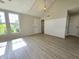 Bright living room featuring large windows, vaulted ceilings, and modern flooring at 6369 Kelsey Dr, Indianapolis, IN 46268