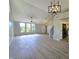 Spacious living room with vaulted ceilings, modern lighting, staircase, and open kitchen layout at 6369 Kelsey Dr, Indianapolis, IN 46268