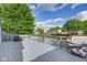 A backyard view shows a spacious gray deck overlooking a pond with houses in the background at 6707 Greendale Ln, Indianapolis, IN 46241
