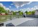 Peaceful backyard view from a deck, showcasing a pond, green trees, blue skies, and neighboring homes at 6707 Greendale Ln, Indianapolis, IN 46241