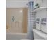 Bathroom featuring a shower-tub combination, toilet, vanity with sink, decorative shelves and towels at 6707 Greendale Ln, Indianapolis, IN 46241
