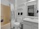 Simple bathroom with a toilet, tub-shower, vanity with mirror, and neutral-colored walls and flooring at 6707 Greendale Ln, Indianapolis, IN 46241