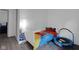 bedroom with a bed, trampoline, a floor lamp, and gray laminate flooring at 6707 Greendale Ln, Indianapolis, IN 46241