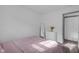Cozy bedroom featuring a bed with a soft comforter, a white dresser with a mirror and flowers on top at 6707 Greendale Ln, Indianapolis, IN 46241