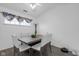 Dining area with wood-look floors, white walls and trim, a square table, and seating for four at 6707 Greendale Ln, Indianapolis, IN 46241
