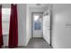 Hallway featuring hardwood floors, white trim, and a back door with a blue security screen door at 6707 Greendale Ln, Indianapolis, IN 46241