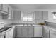 The Kitchen includes white appliances, laminate countertops, and ample cabinet space with a window at 6707 Greendale Ln, Indianapolis, IN 46241